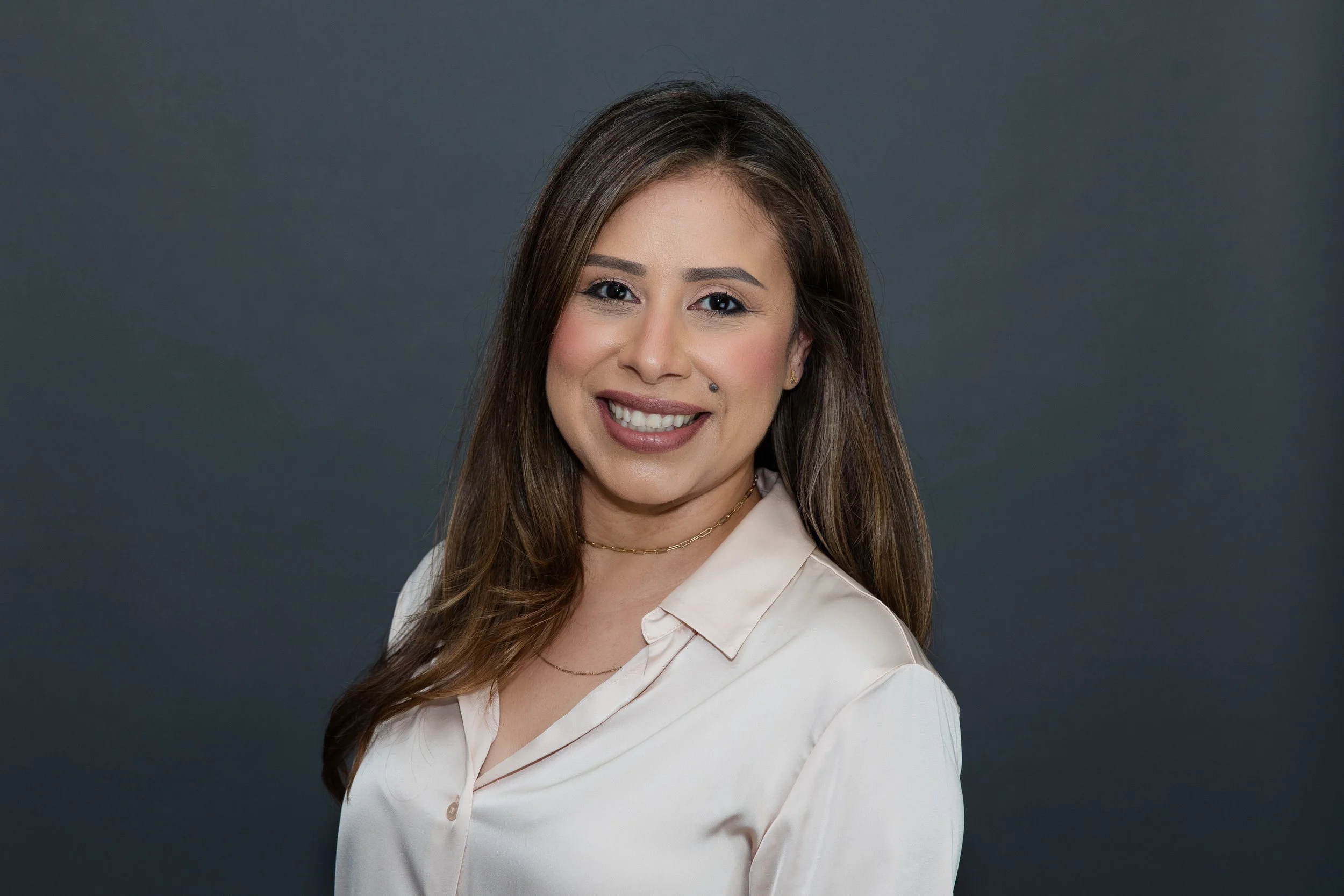 woman in beige blouse headshot.jpg
