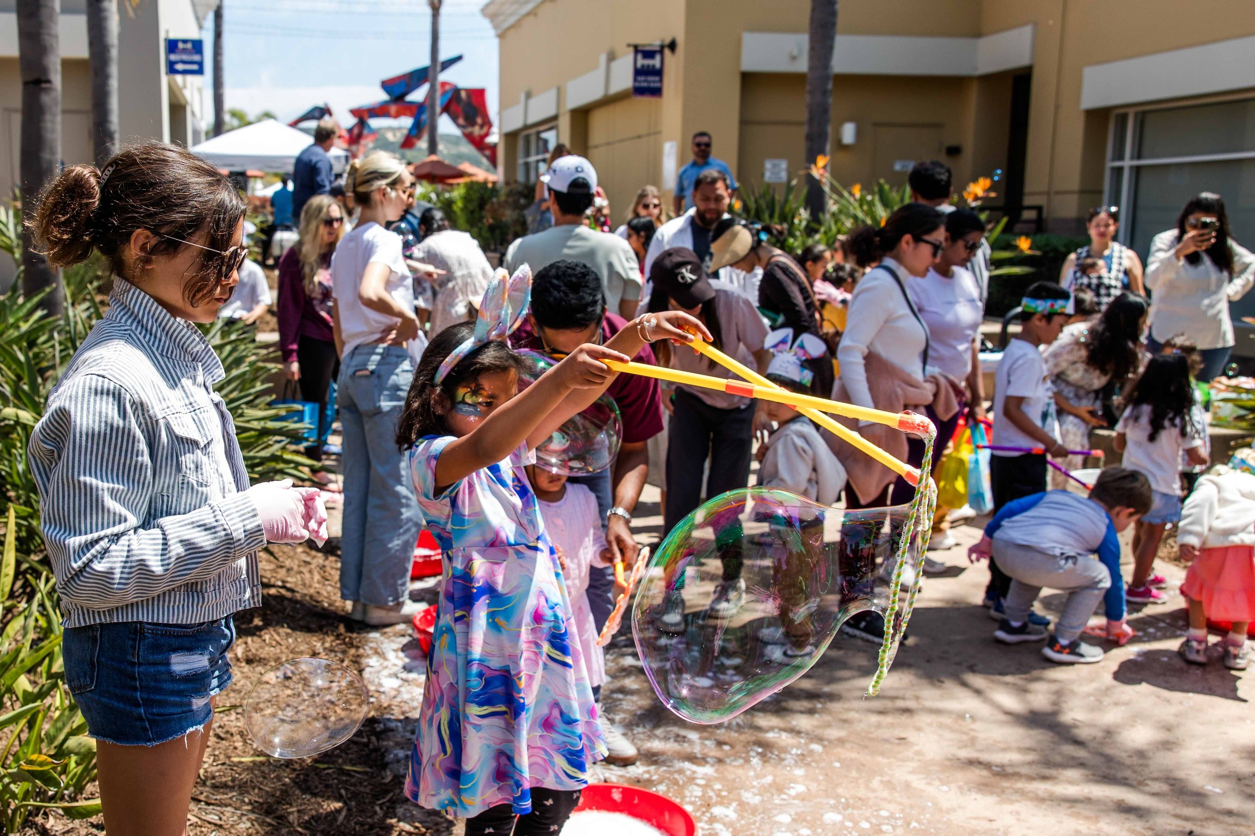 crowd playing with bubbles