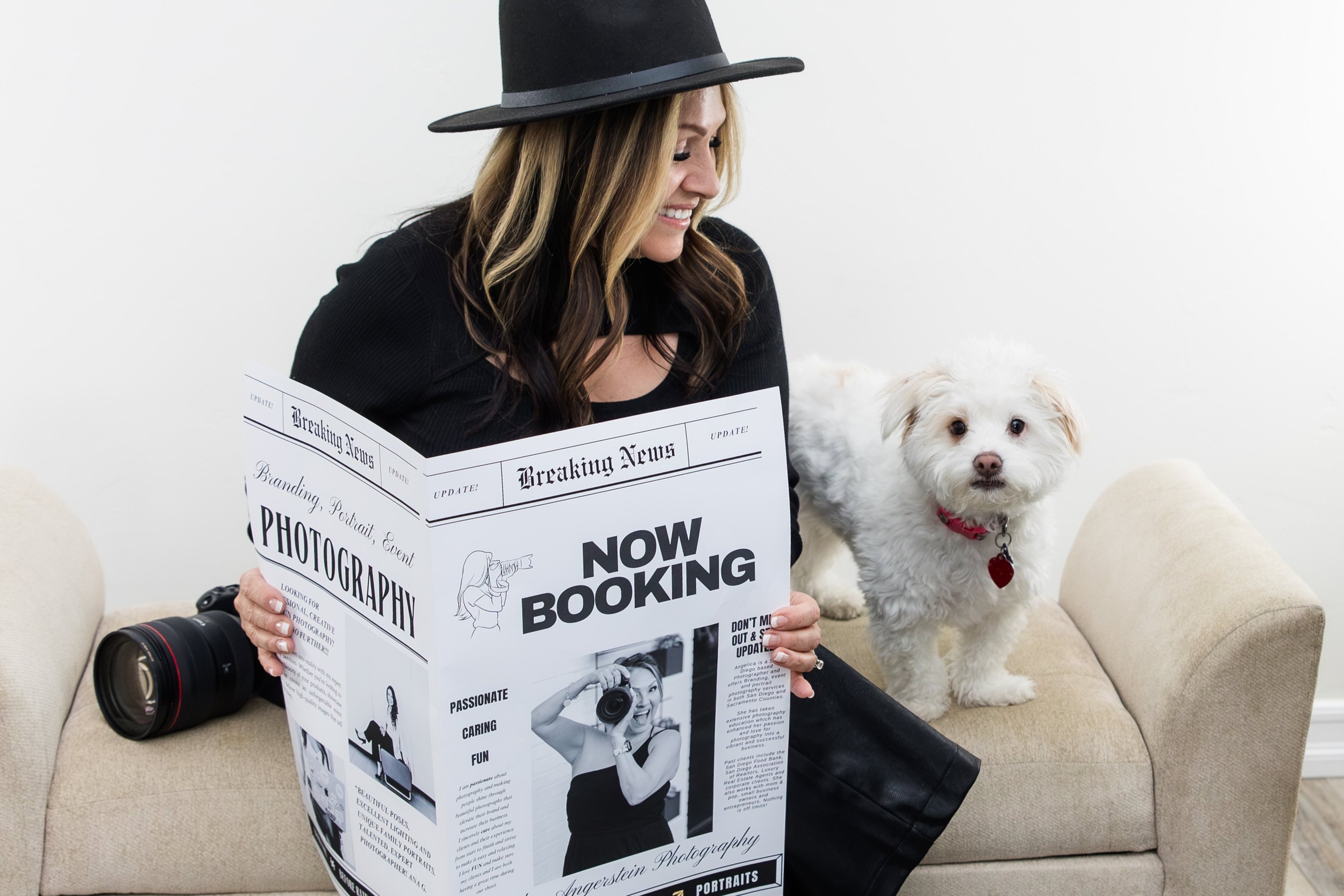 woman holding newspaper dog camera