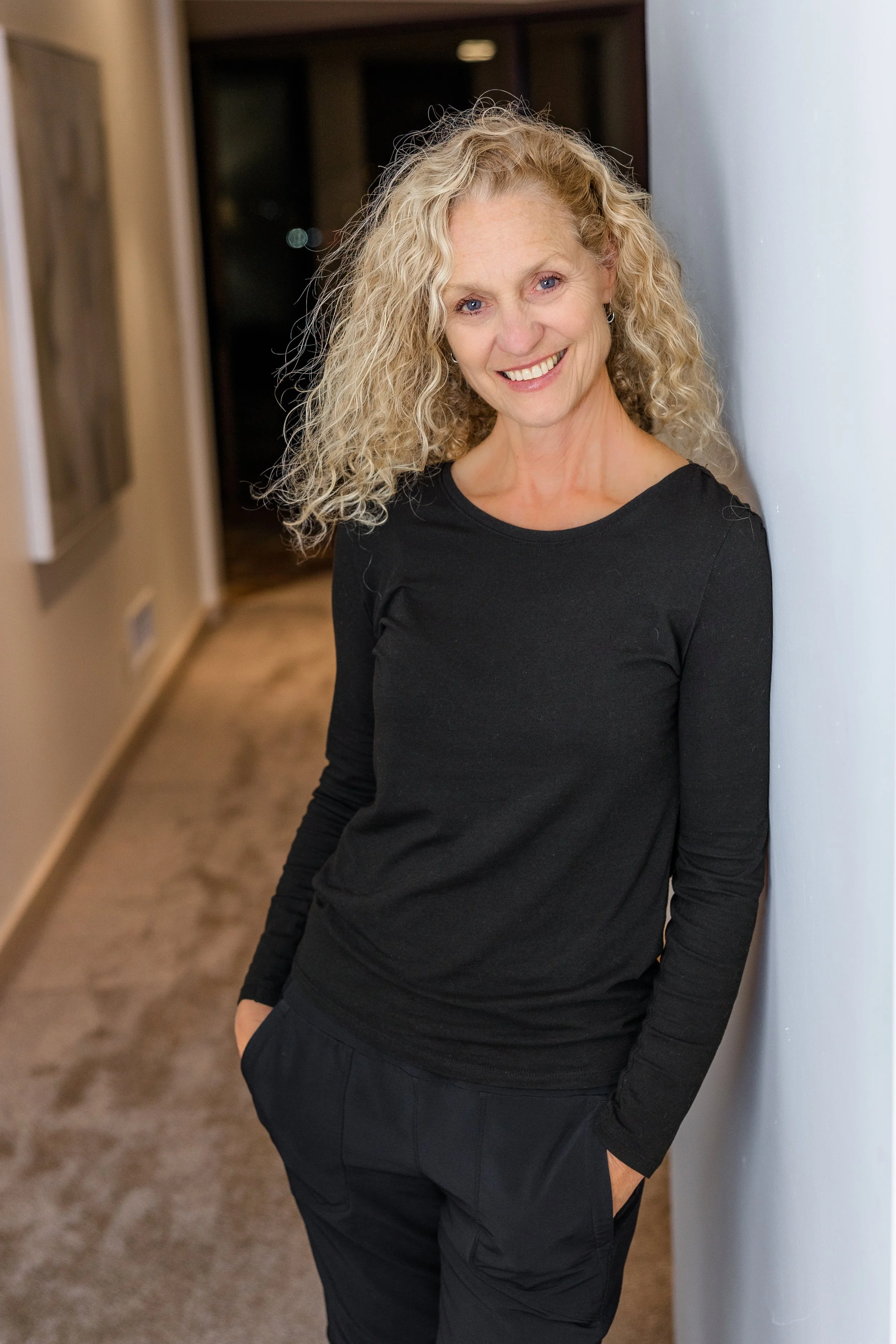 woman standing in hallway smiling.jpg