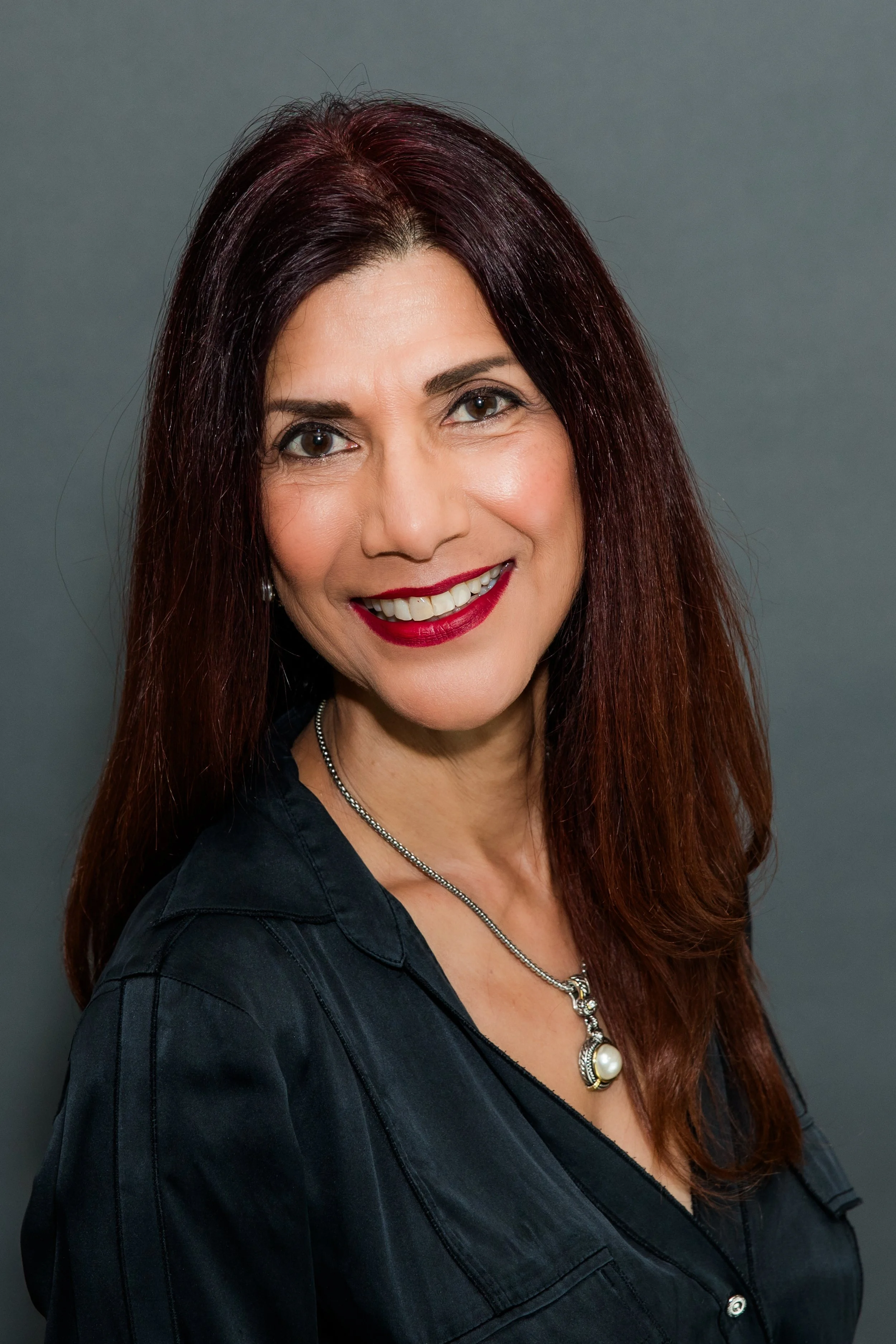 hispanic headshot woma in black shirt.jpg