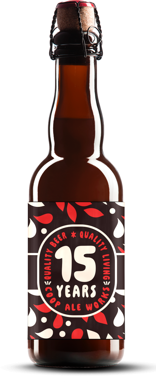 A brown glass beer bottle with a red cap and a black, red, and white label celebrating 15 years of a craft ale brewery.