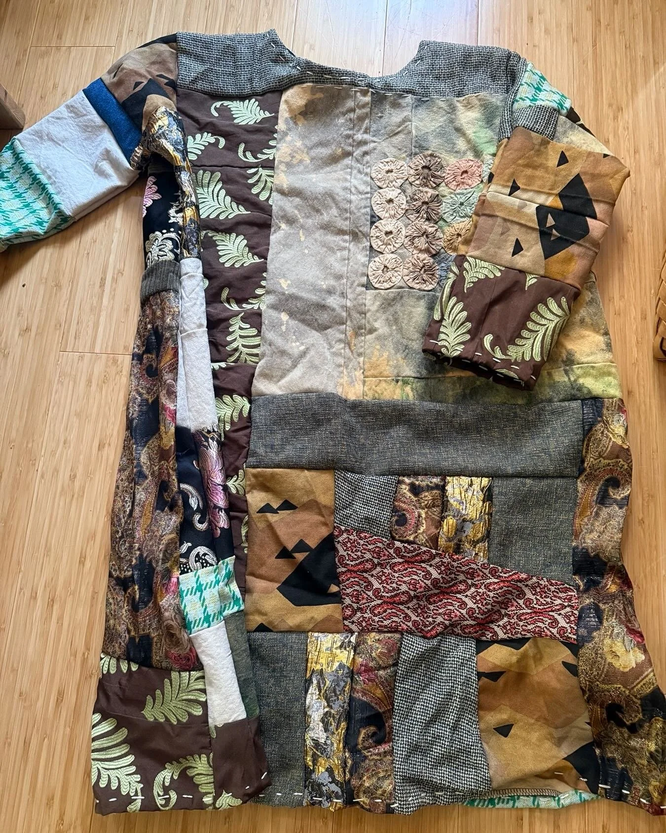 HUGE 3 ply bag of cloth scraps that I brought up to my new studio/loft space where I now live. I dumped them out on the floor and selected pieces that made me ask why? What was it about this cloth that attracted me? So I started improv piecing each o