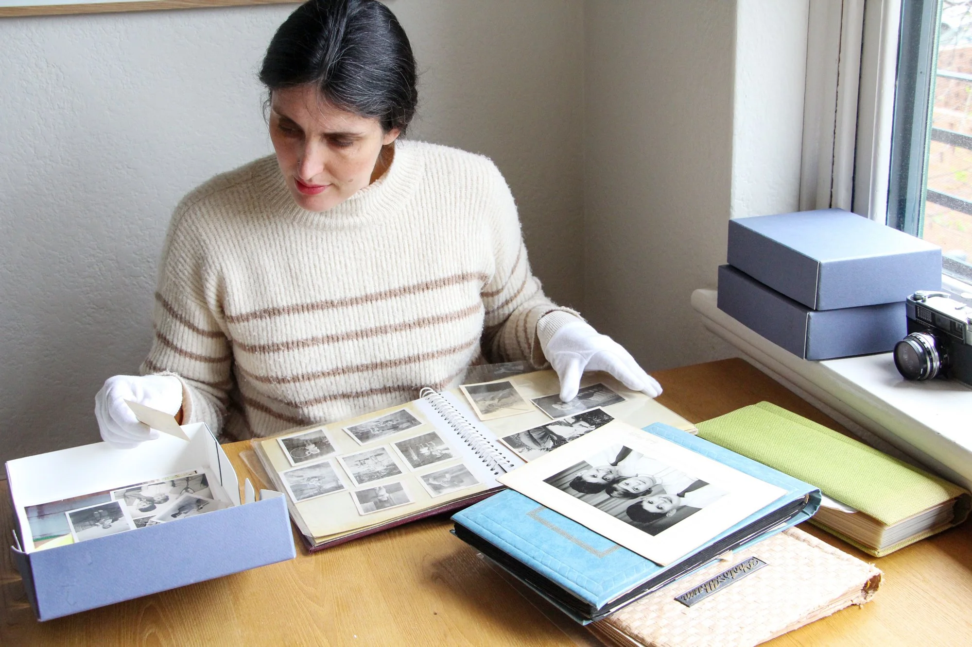 Melanie Sorting through a Photo Album of Prints