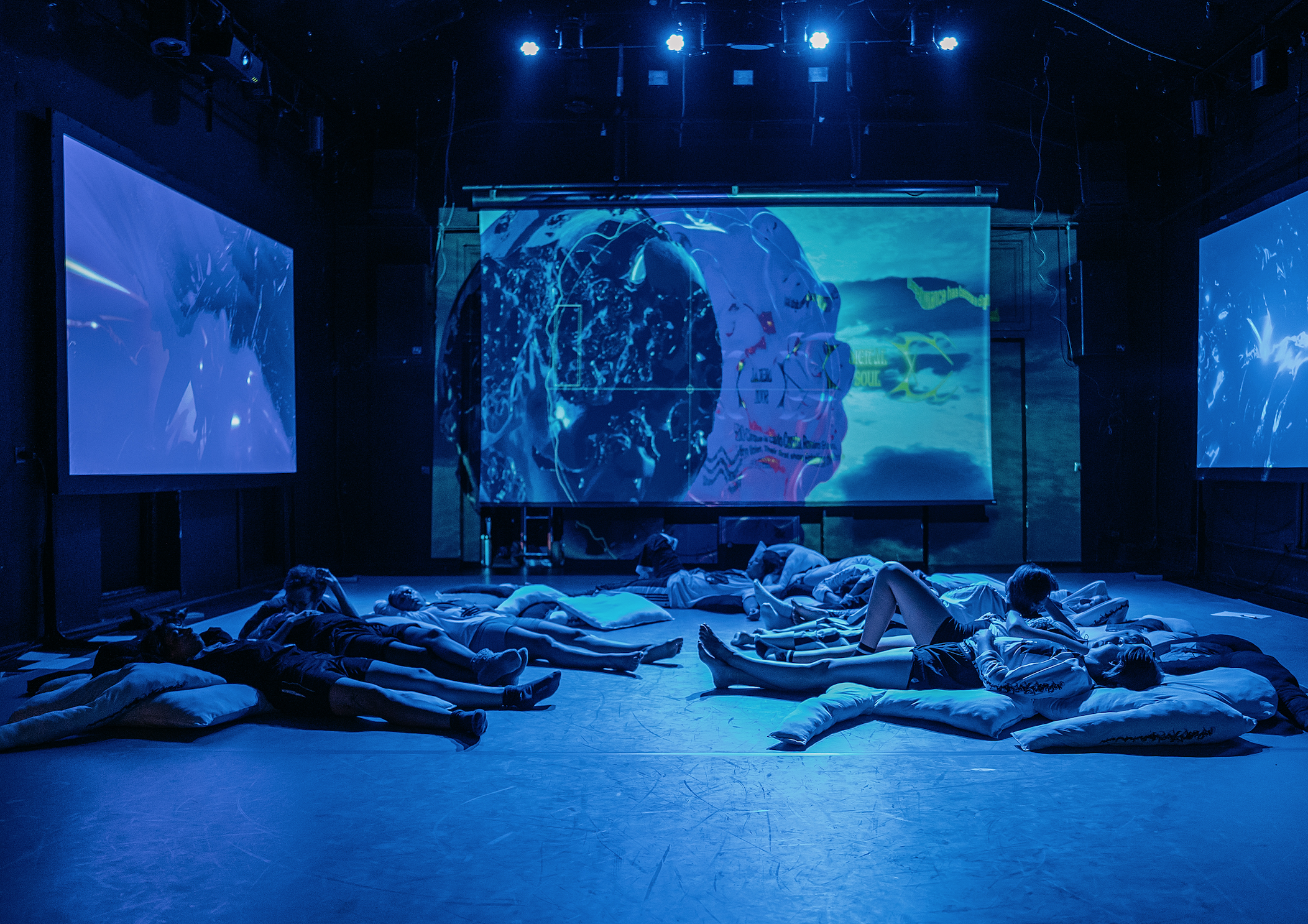 The Sphere - A photo of The Sphere’s experimental devising processes. An embodied experiment during a research LARP hosted by Lene Vollhardt - a Live Action Role-Playing Game exploring ideas of value and exchange.  Various people lie down in a perfor