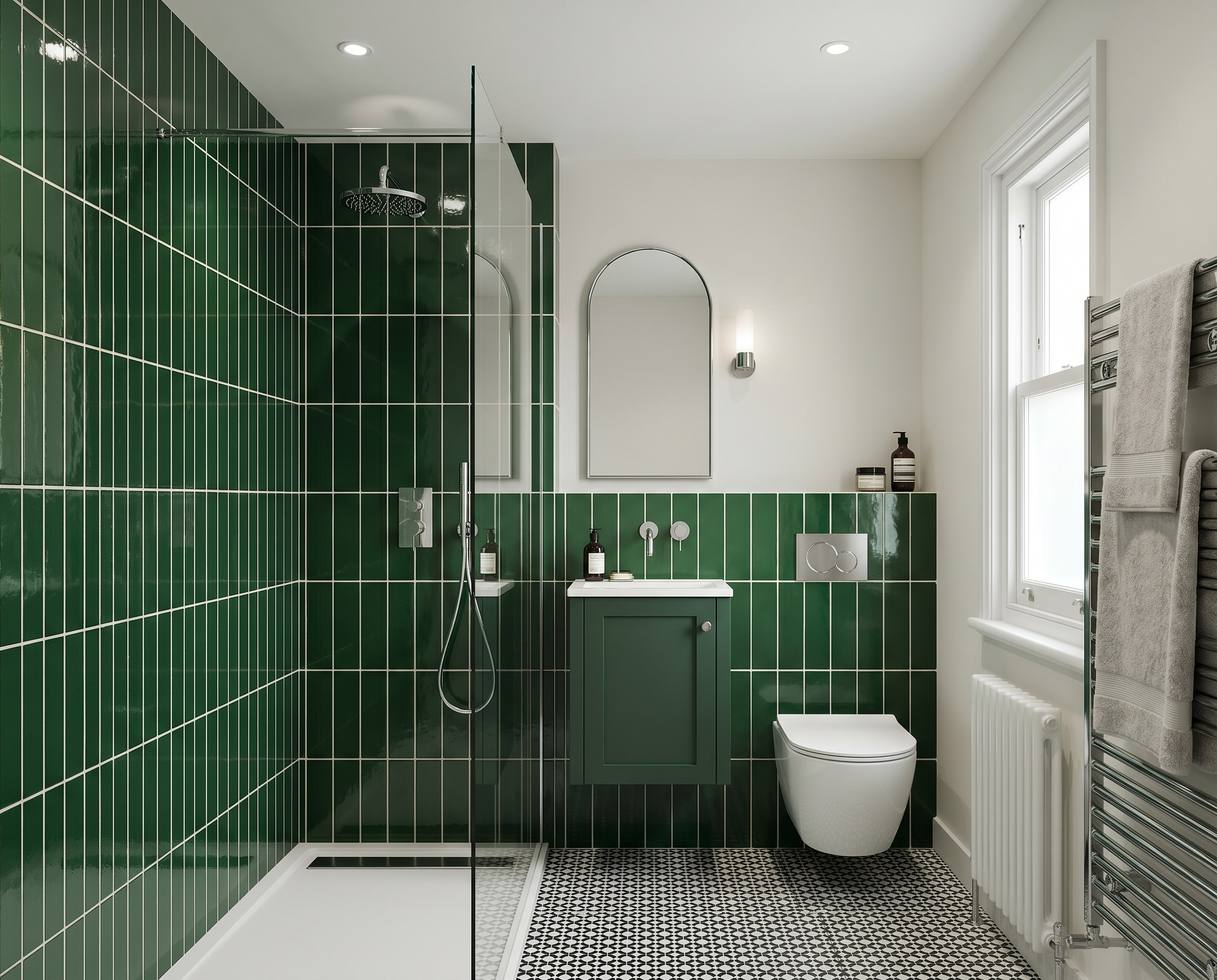 Modern bathroom with a green tiled shower area, a white toilet, a large window, a wall mirror, and towels hanging on a chrome towel rail.