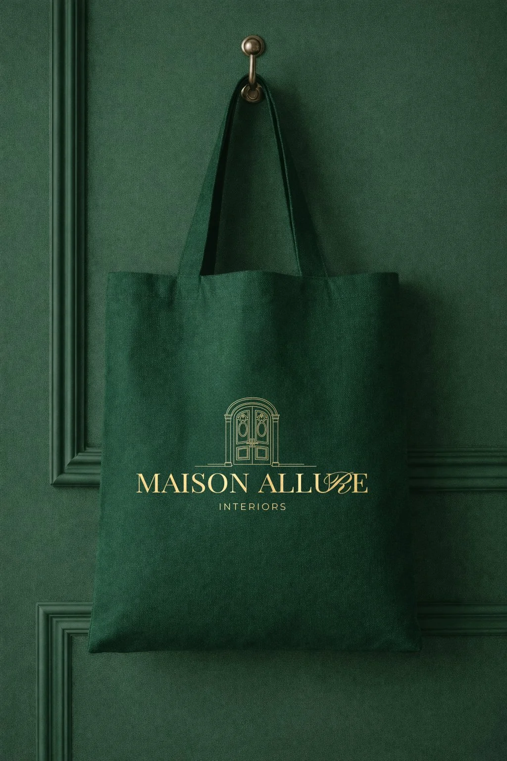 Maison Allure branded tote bag mockup featuring a deep green fabric tote with gold logo and doorway icon on an elegant green interior backdrop.