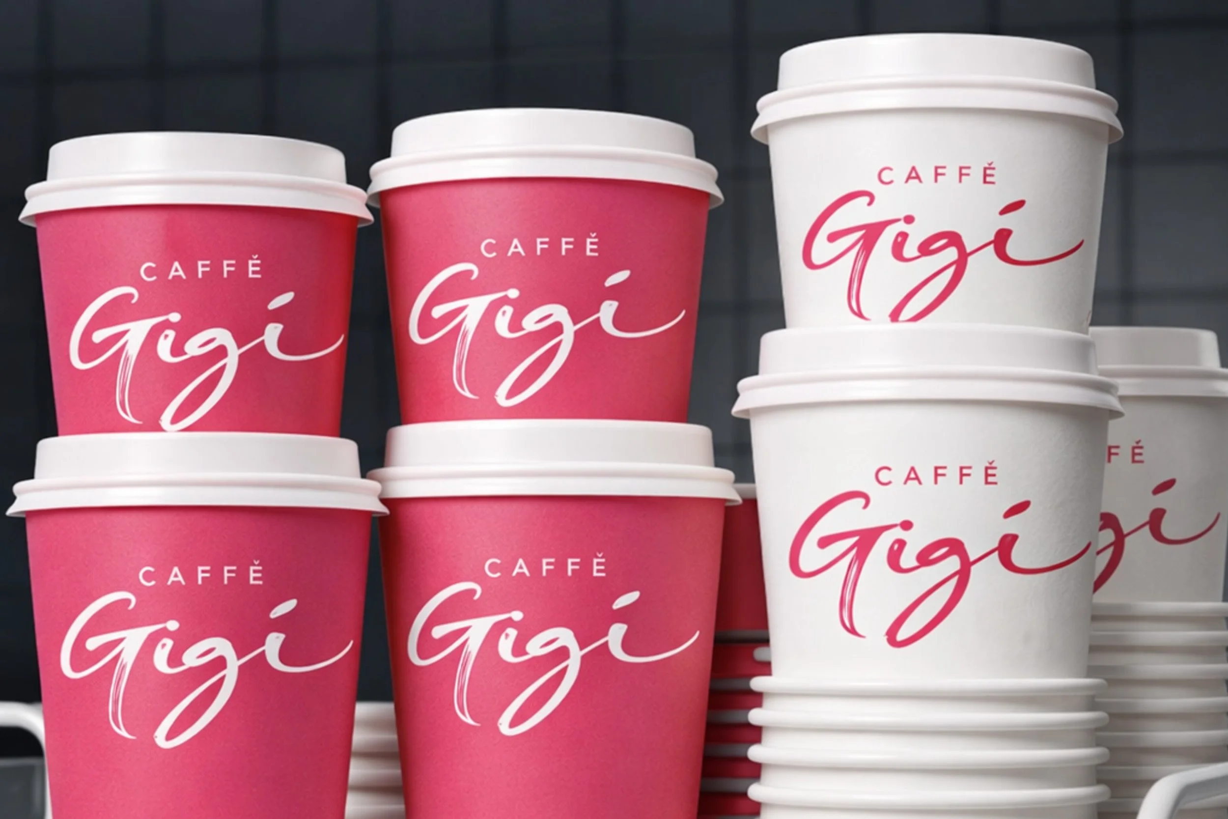 Caffè Gigi takeaway coffee cup mockup featuring stacked pink and white branded cups with the café logo.