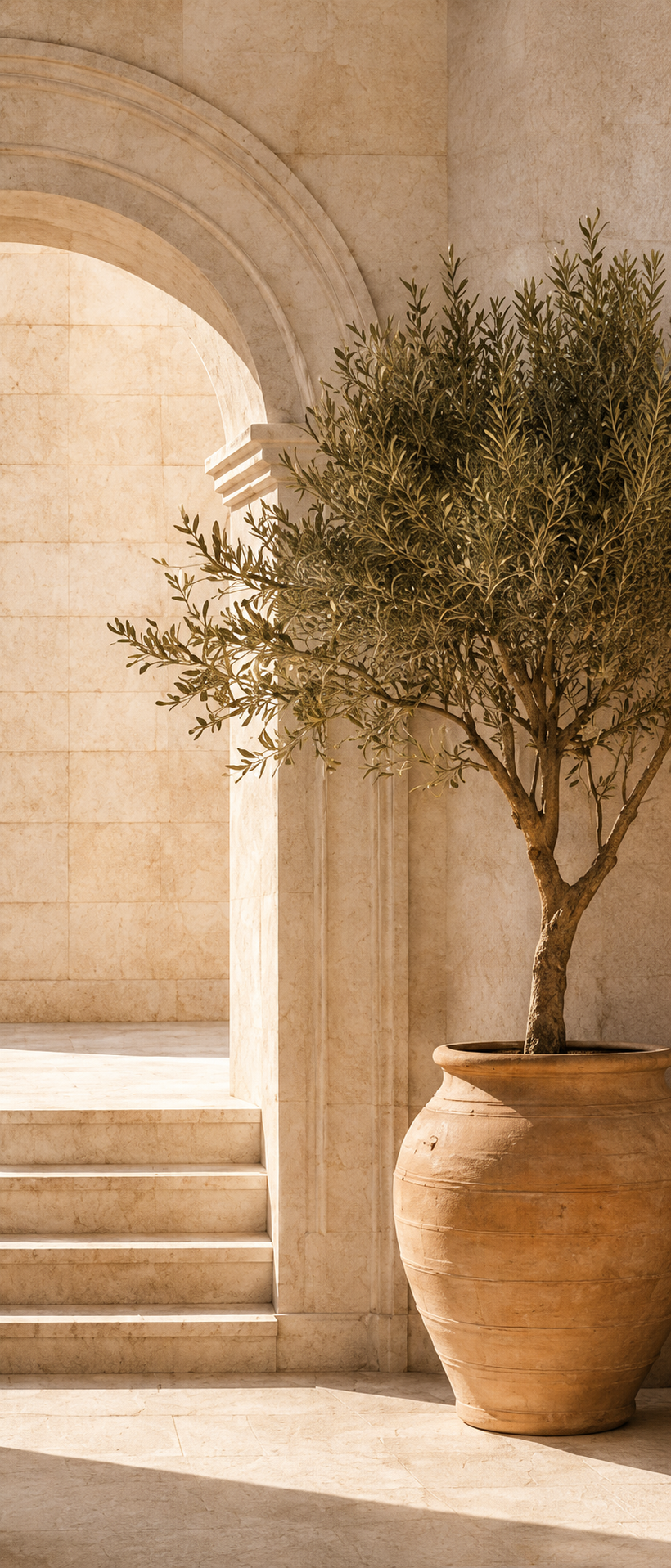 Mediterranean stone arch and olive tree representing consistency in luxury branding, with warm neutral tones and timeless architectural details.
