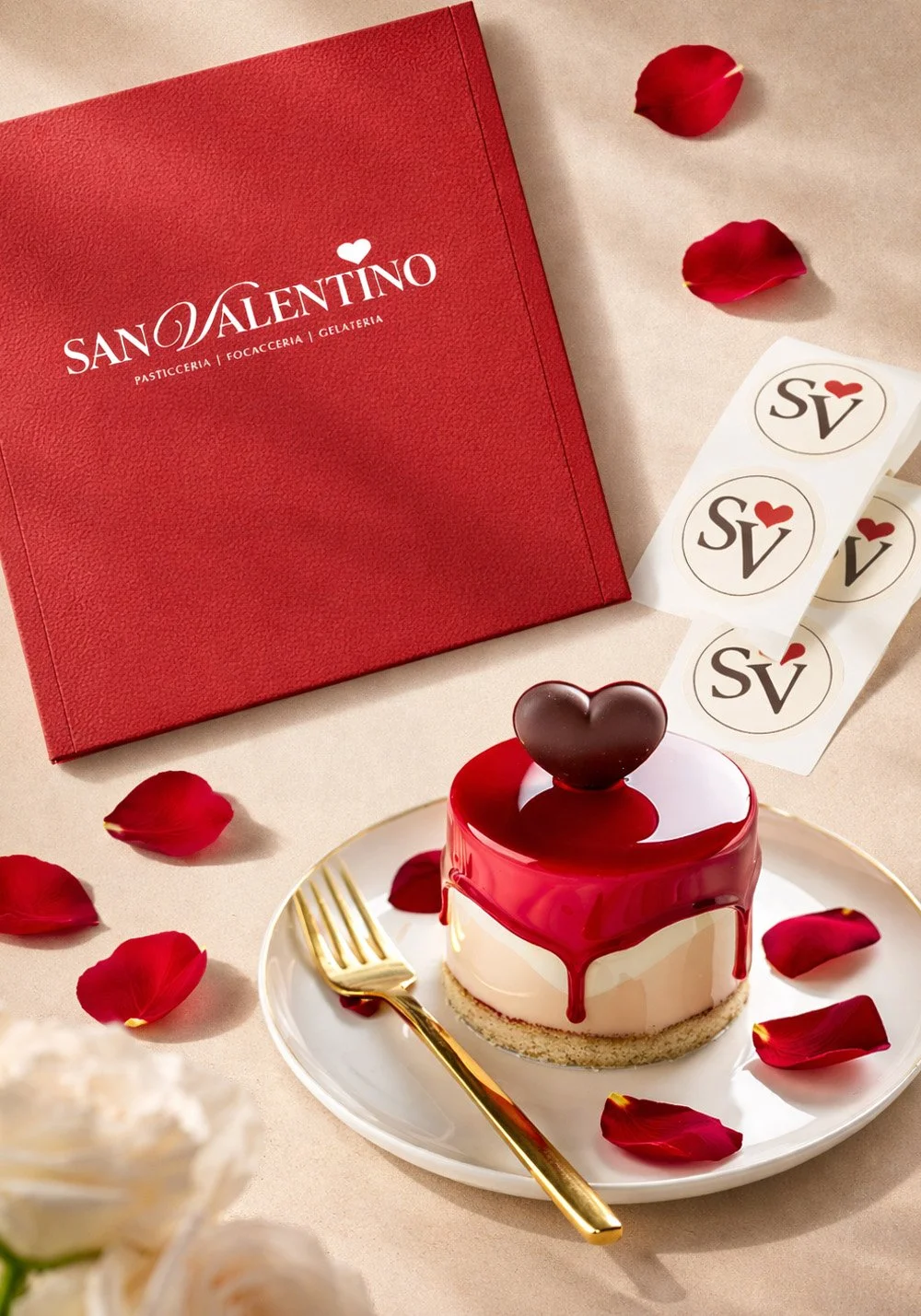 San Valentino Pasticceria dessert branding mockup featuring a red heart dessert, branded menu cover, SV logo stickers and romantic rose petal styling.