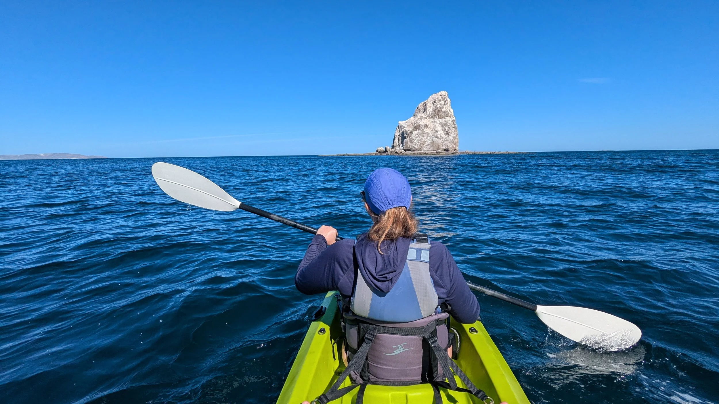 Kayaking to solitary rock at Bahia Agua Verde in Baja Mexico with UnCruise