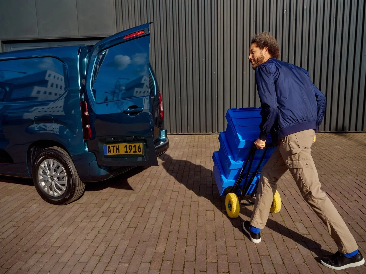 Delivery driver with blue boxes at his van, Athlon Car Lease shoot in Amsterdam