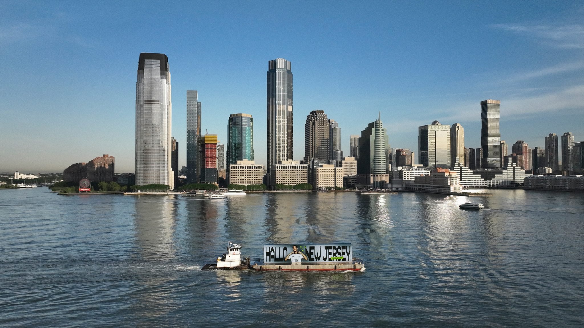 Billboard barge with 'Hallo New Jersey' on the Hudson River in front of the Jersey City skyline, Nike Football Jamal Musiala World Cup 2026