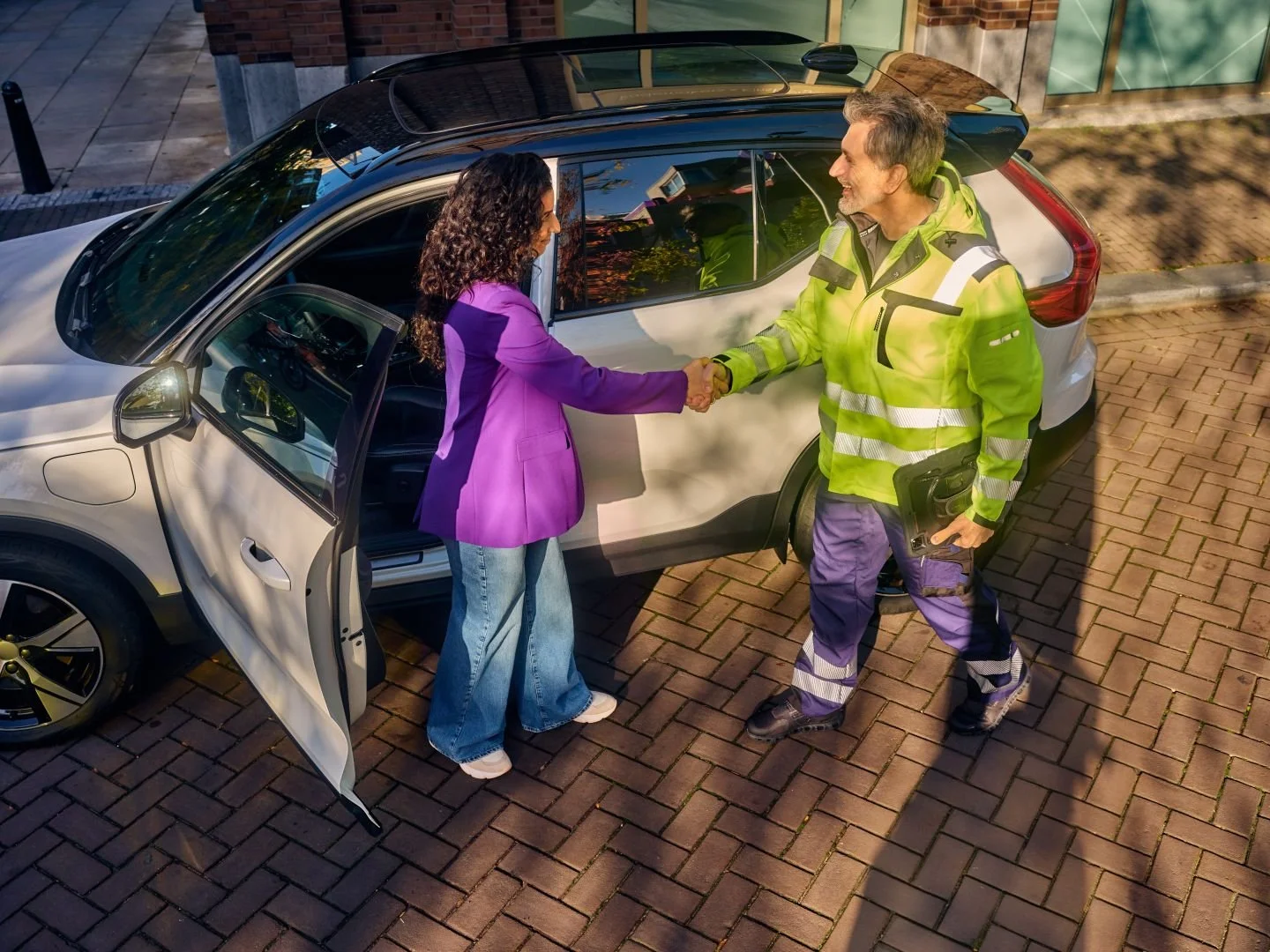 Driver shaking hands with a roadside assistance mechanic, Athlon Car Lease shoot in Amsterdam