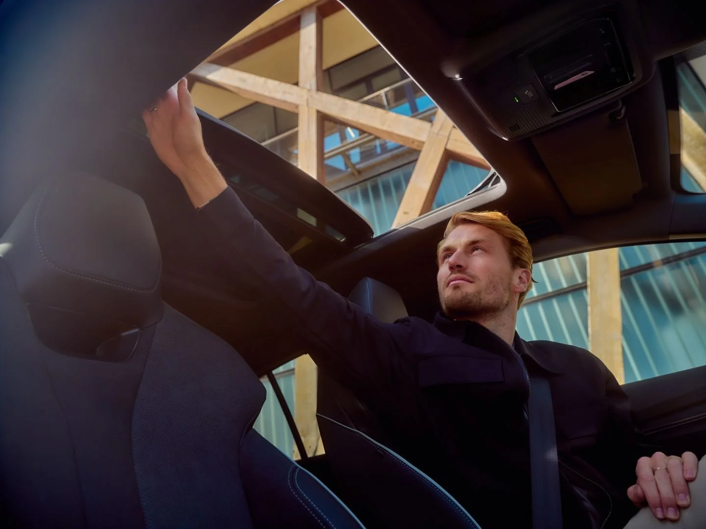 Man opening the sunroof while driving, Athlon Car Lease shoot in Amsterdam