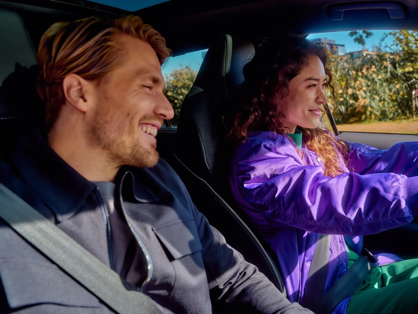 Woman driving with a male passenger, talking, Athlon Car Lease shoot in Amsterdam
