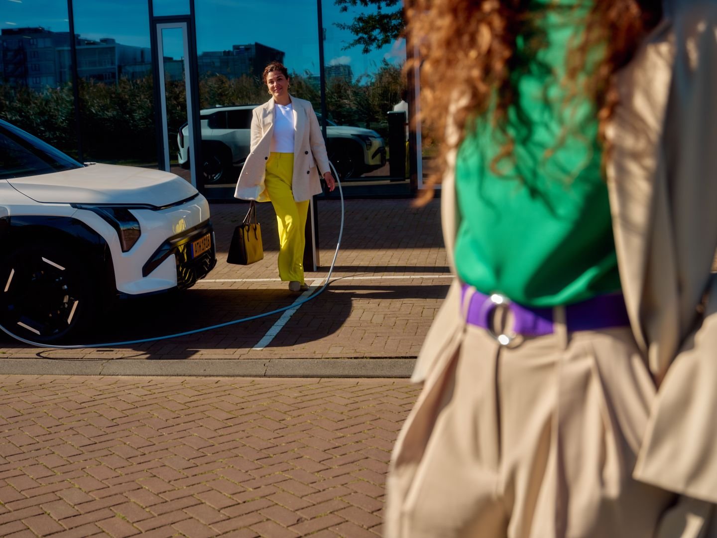Woman meeting a colleague in the city, Athlon Car Lease shoot in Amsterdam