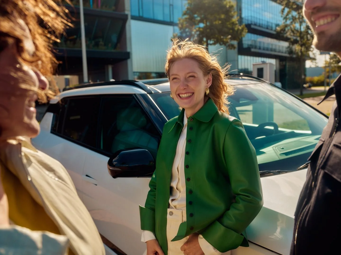 Woman smiling next to her parked company car, Athlon Car Lease shoot in Amsterdam