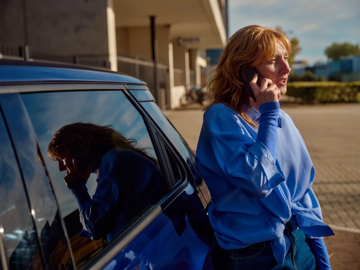 Woman on the phone with driver support, Athlon Car Lease shoot in Amsterdam