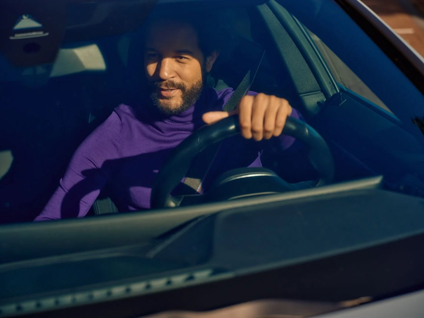 Man behind the wheel of his car, Athlon Car Lease shoot in Amsterdam