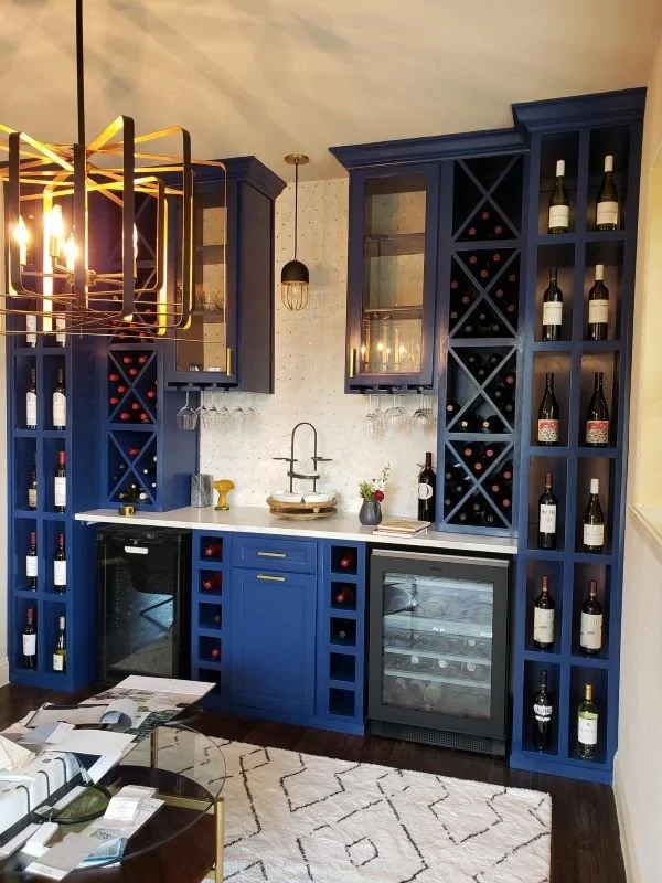 blue wine cabinet with marble backsplash