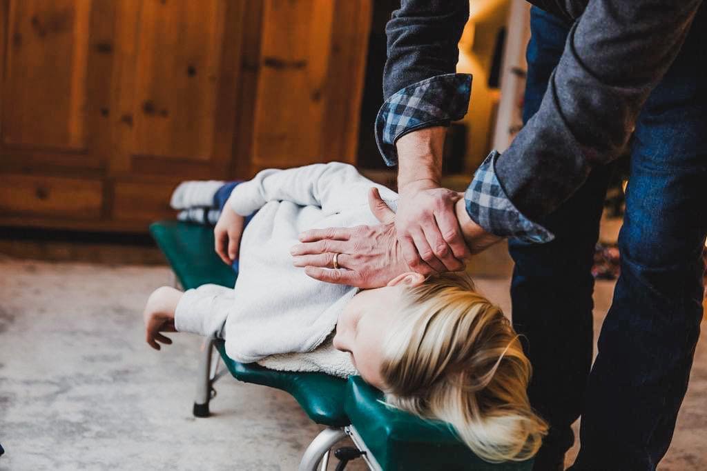 Child receiving a gentle chiropractic neck adjustment