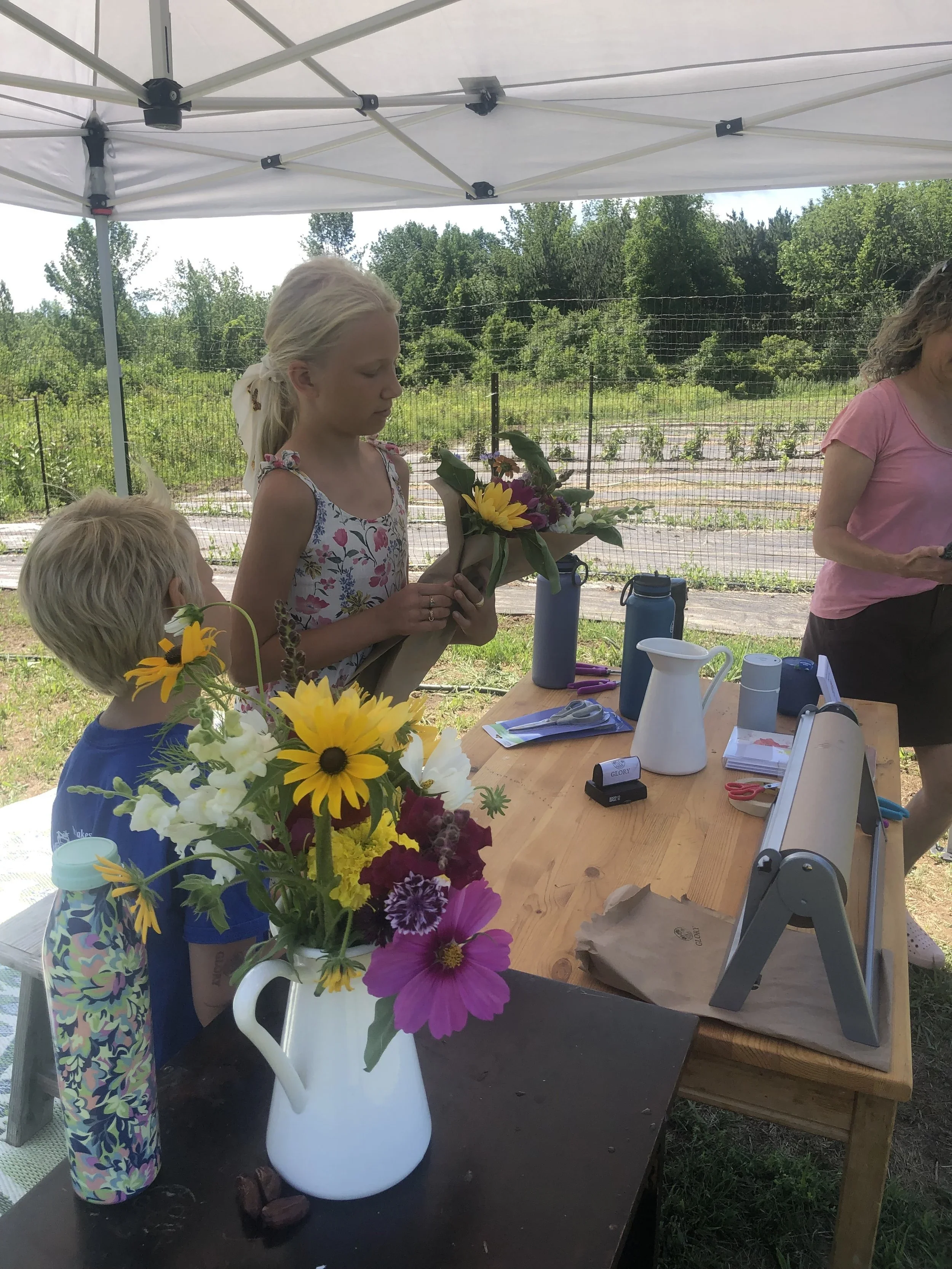 Family member at Glory Flower Farm in Vermont surrounded by flowers