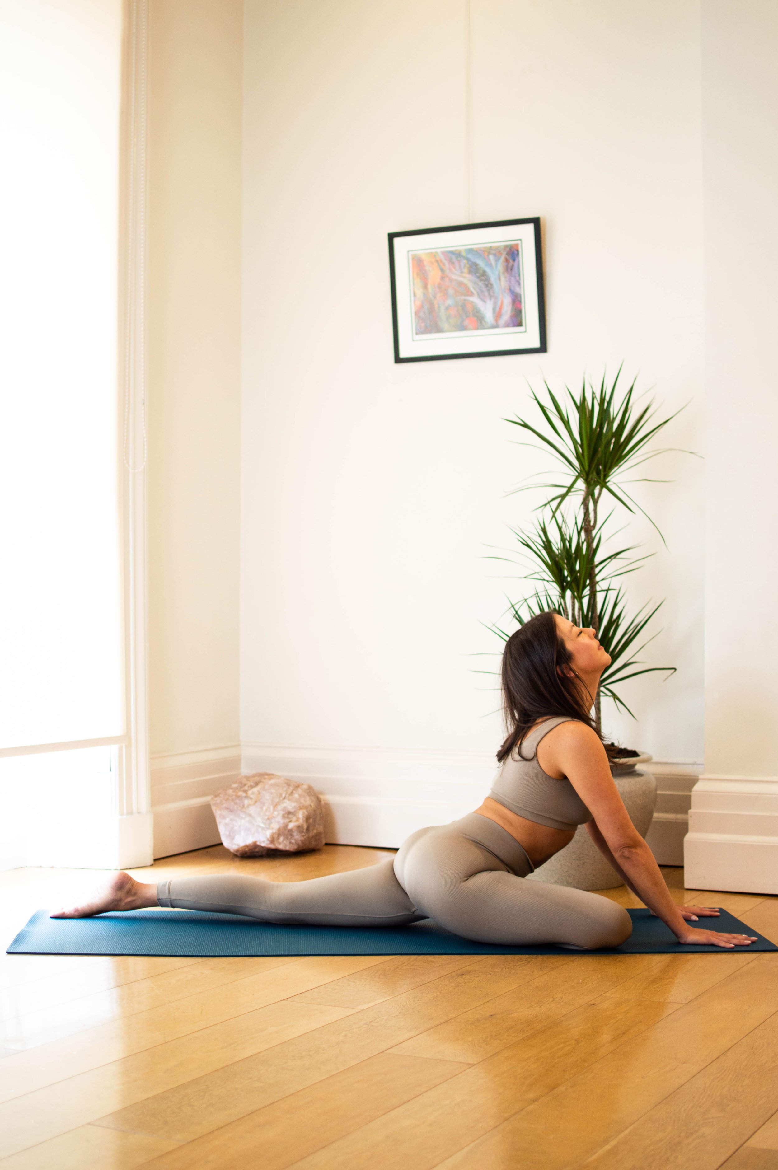 Jen in a pigeon pose, stretching up