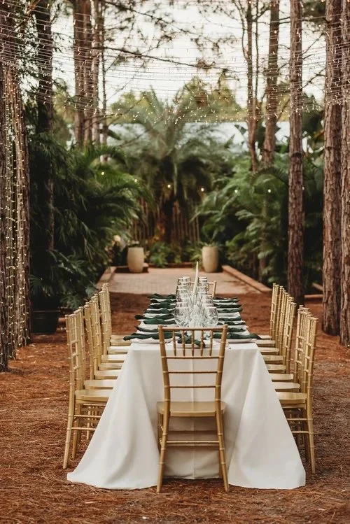 Long dinner table in pine forest at outdoor wedding venue near Tavares Florida