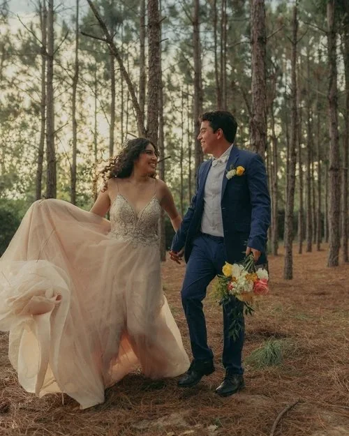 Couple walking through pine forest at outdoor wedding venue near Altamonte Springs Florida