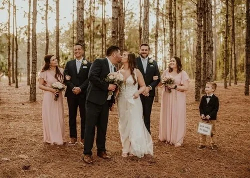 Couple walking through pine forest in golden light at outdoor wedding venue near Tavares Florida