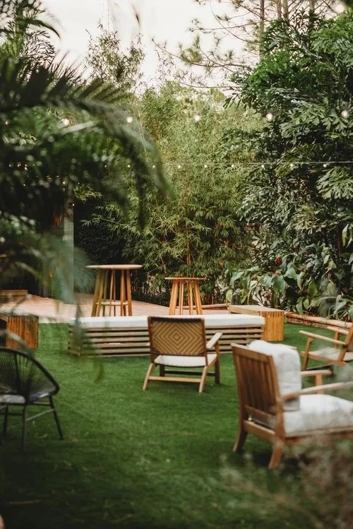 Garden seating area with tropical plants at outdoor wedding venue near St. Cloud Florida