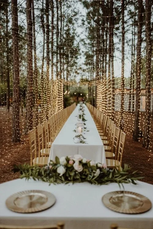 Long dining table in pine forest at outdoor wedding venue near Spring Hill Florida