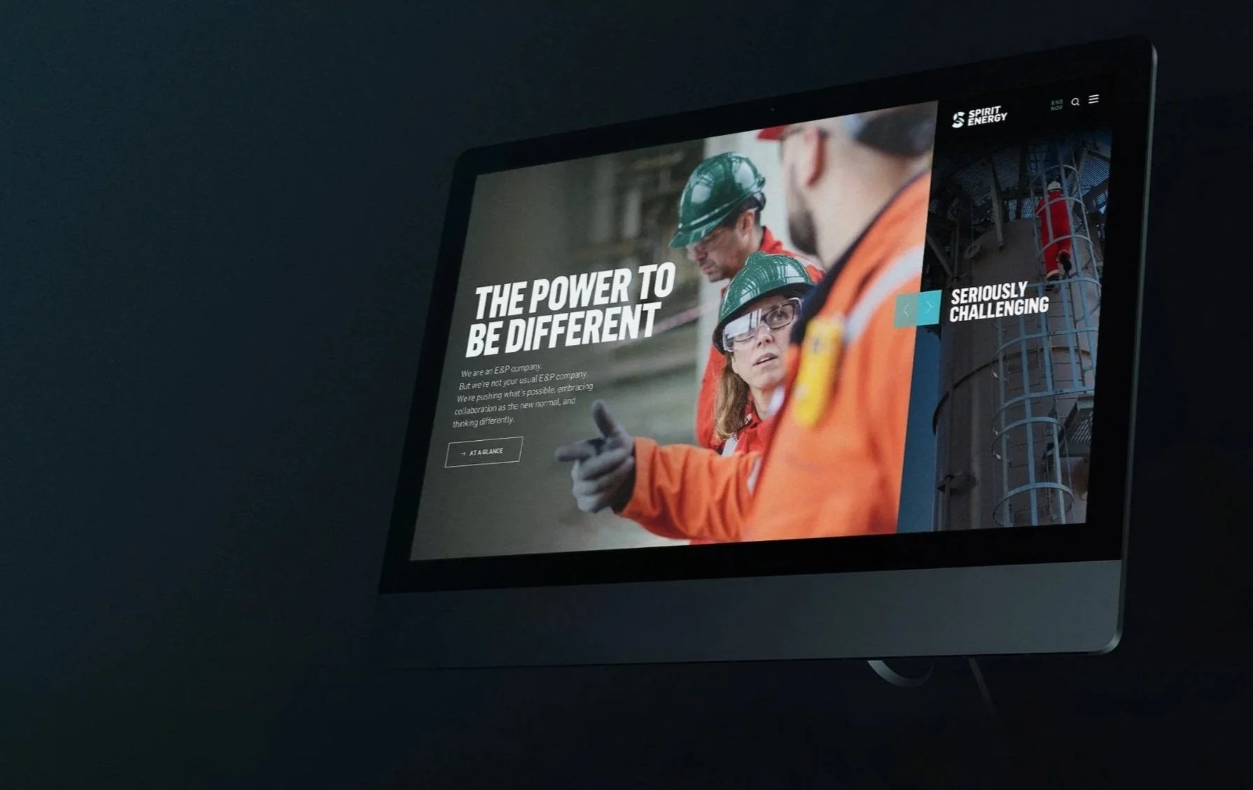 Computer screen displaying a website with a group of people in orange safety gear and helmets, with the text "The power to be different" and "Seriously challenging."