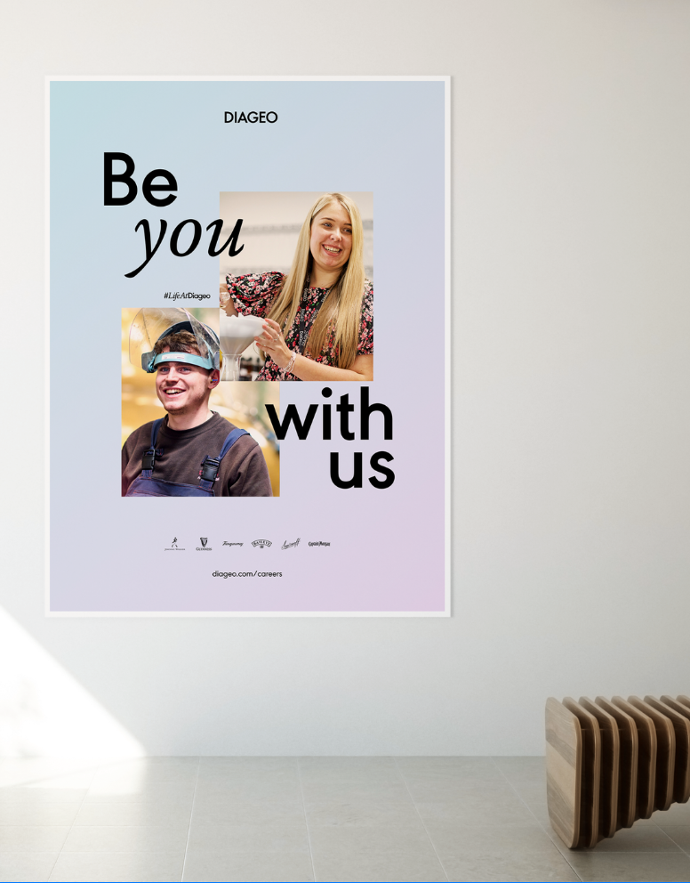 Poster on a white wall with the words 'Be you with us' and photos of a smiling woman and a smiling man, promoting careers at Diageo.