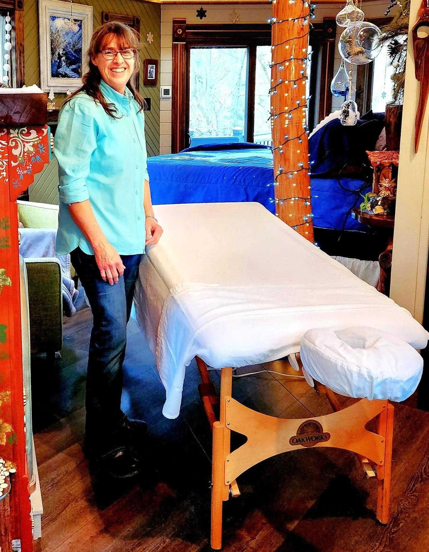 massage therapist waiting next to massage table