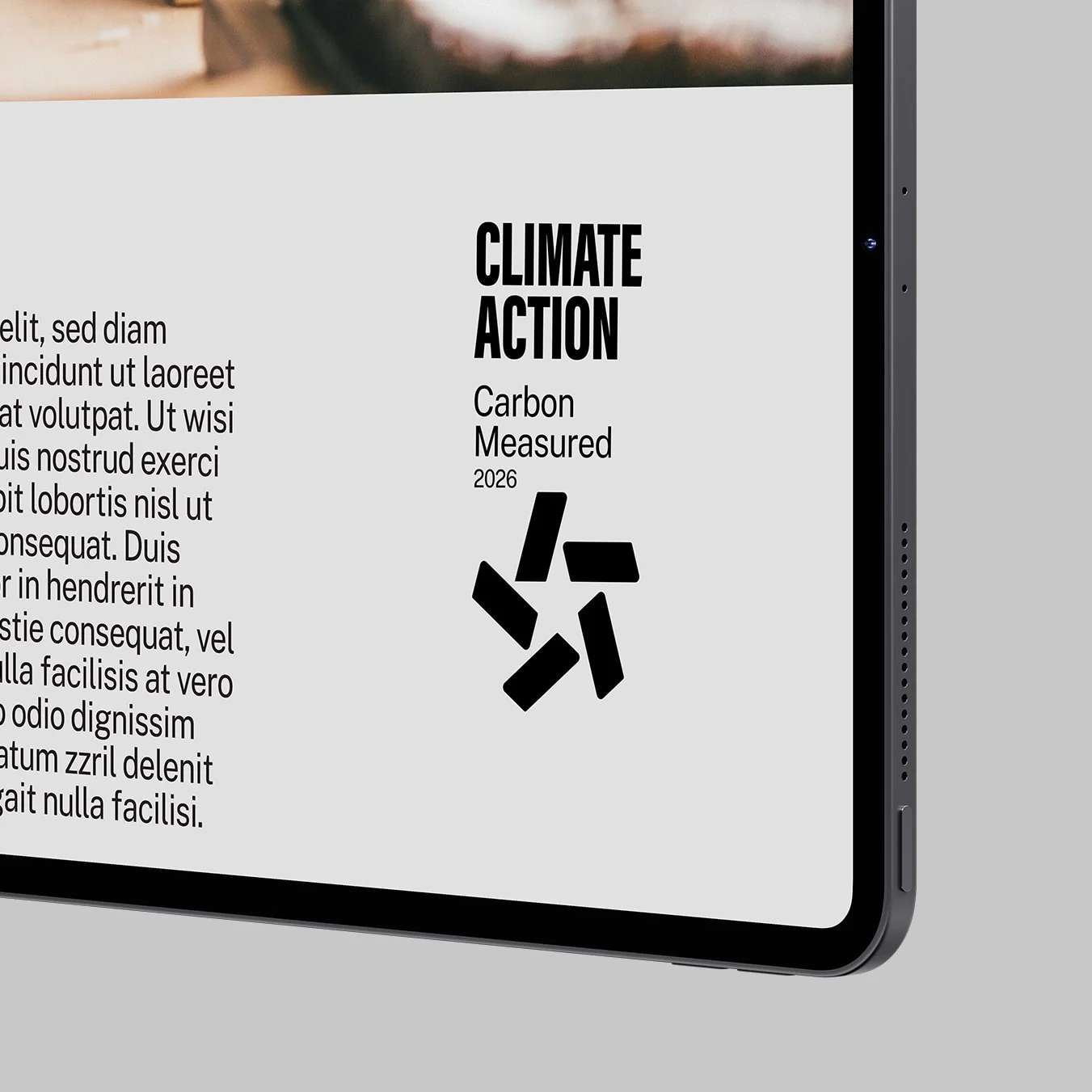 A digital device screen displaying a climate action report with a carbon measurement icon, the text 'Climate Action', 'Carbon Measured', and the year 2026, alongside placeholder text.