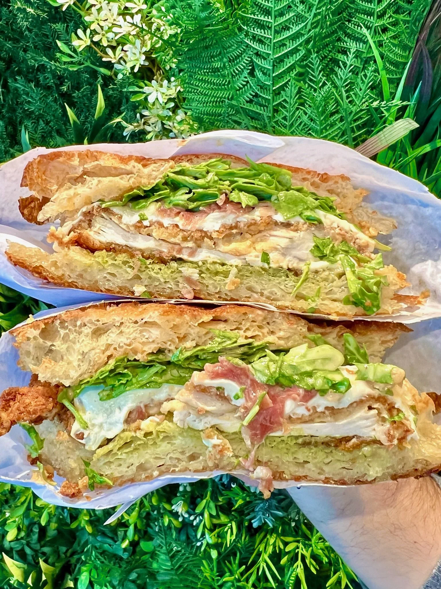 NOISE COMPLAINT chicken cutlet, prosciutto, mozzarella, lemon vinaigrette dressed arugula, pesto, chipotle aioli on Fresh focaccia