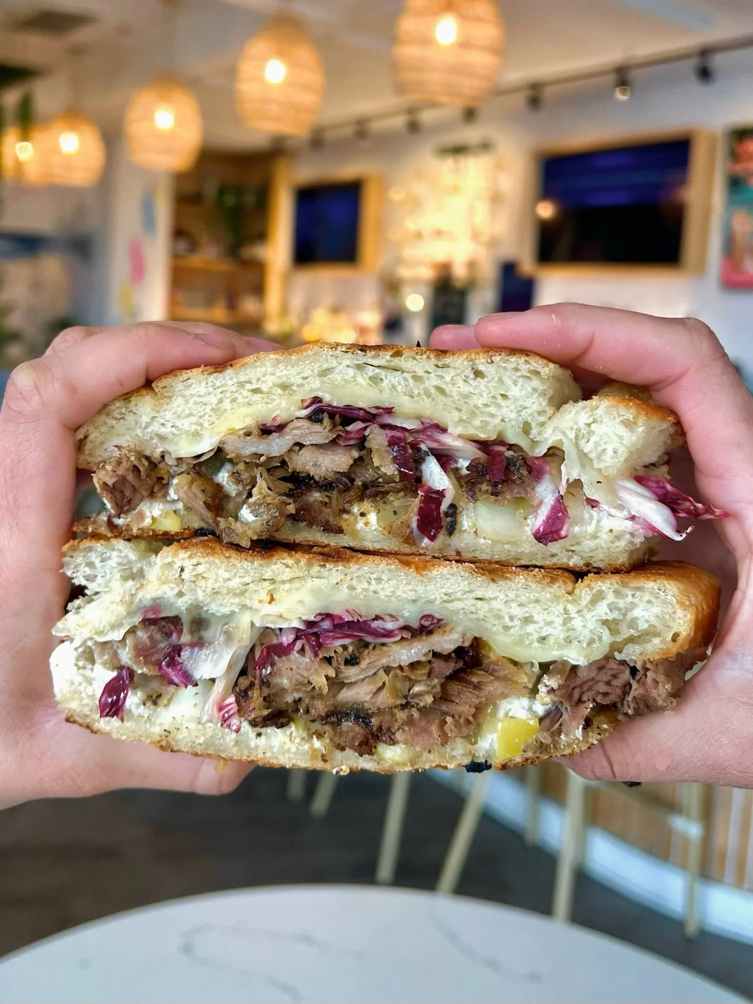 PORKY POOKS slow roasted pork shoulder, whipped lemon ricotta, apple mustarda, provolone, shaved radicchio pressed on sourdough