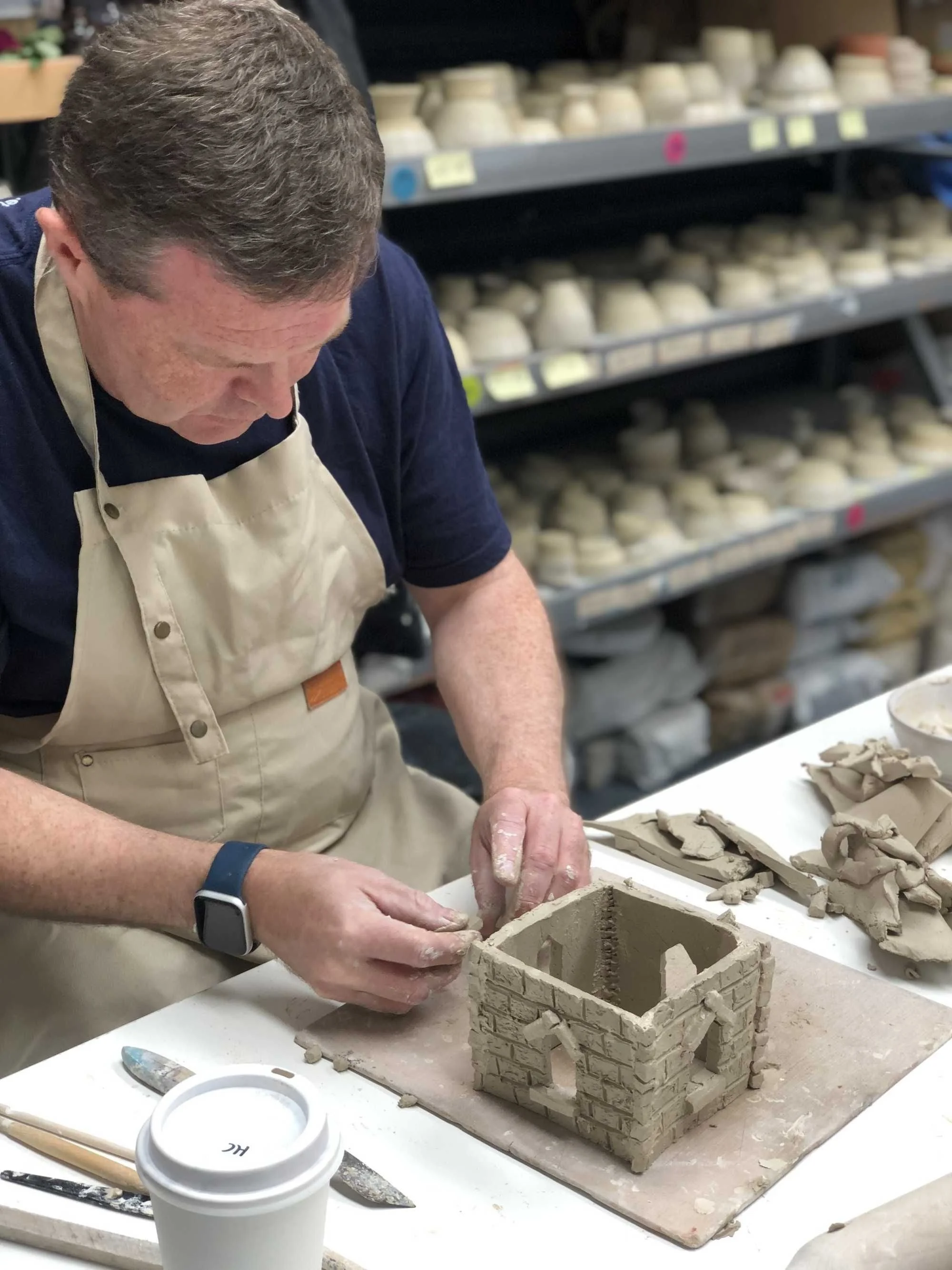 An adult male participant practicing clay hand-building techniques during an inclusive NDIS creative workshop at Kingston Clay Studio in Braeside, Melbourne.