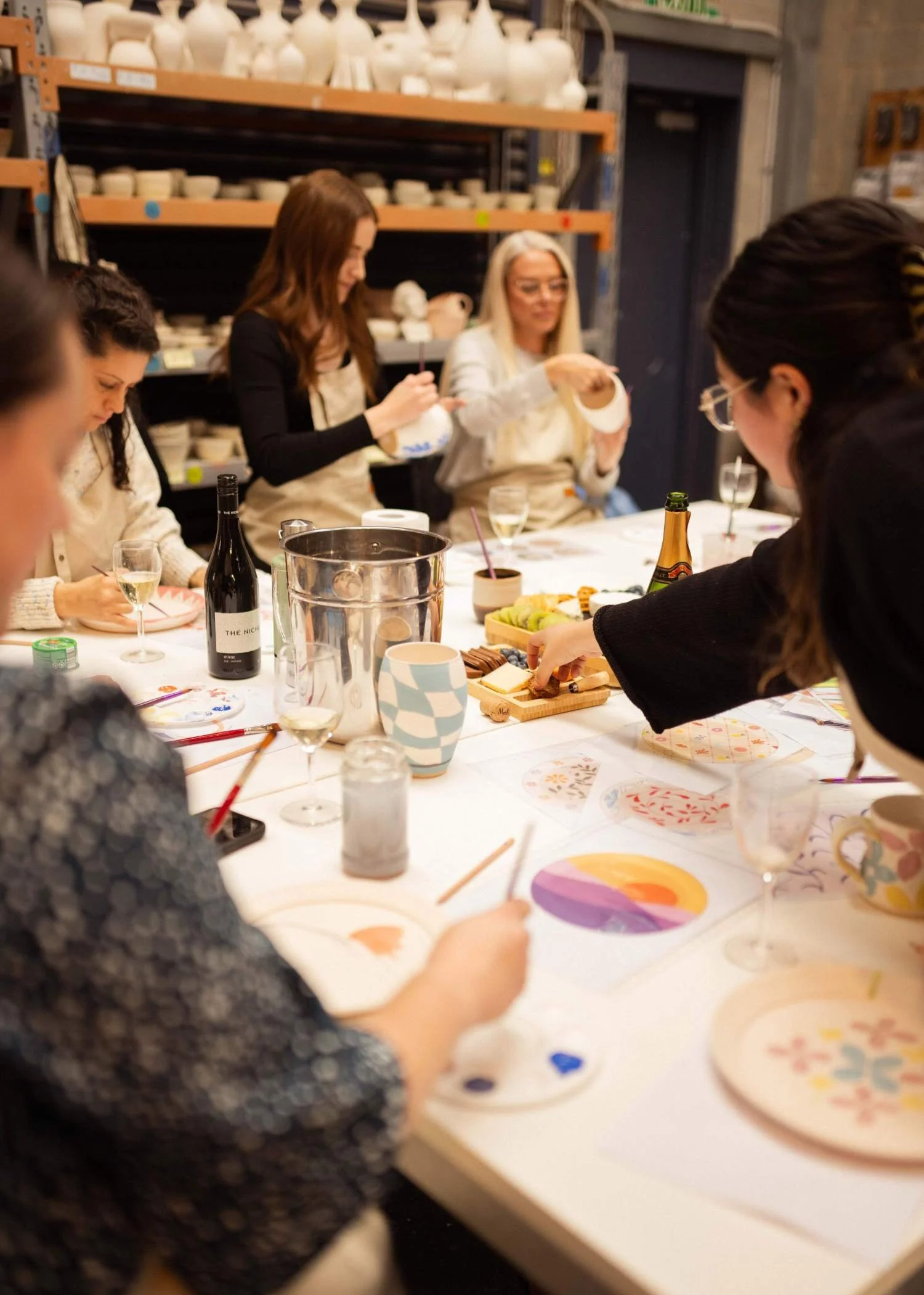 Two people enjoying a creative date night at the Paint and Sculpt Cafe at Kingston Clay Studio in Braeside.