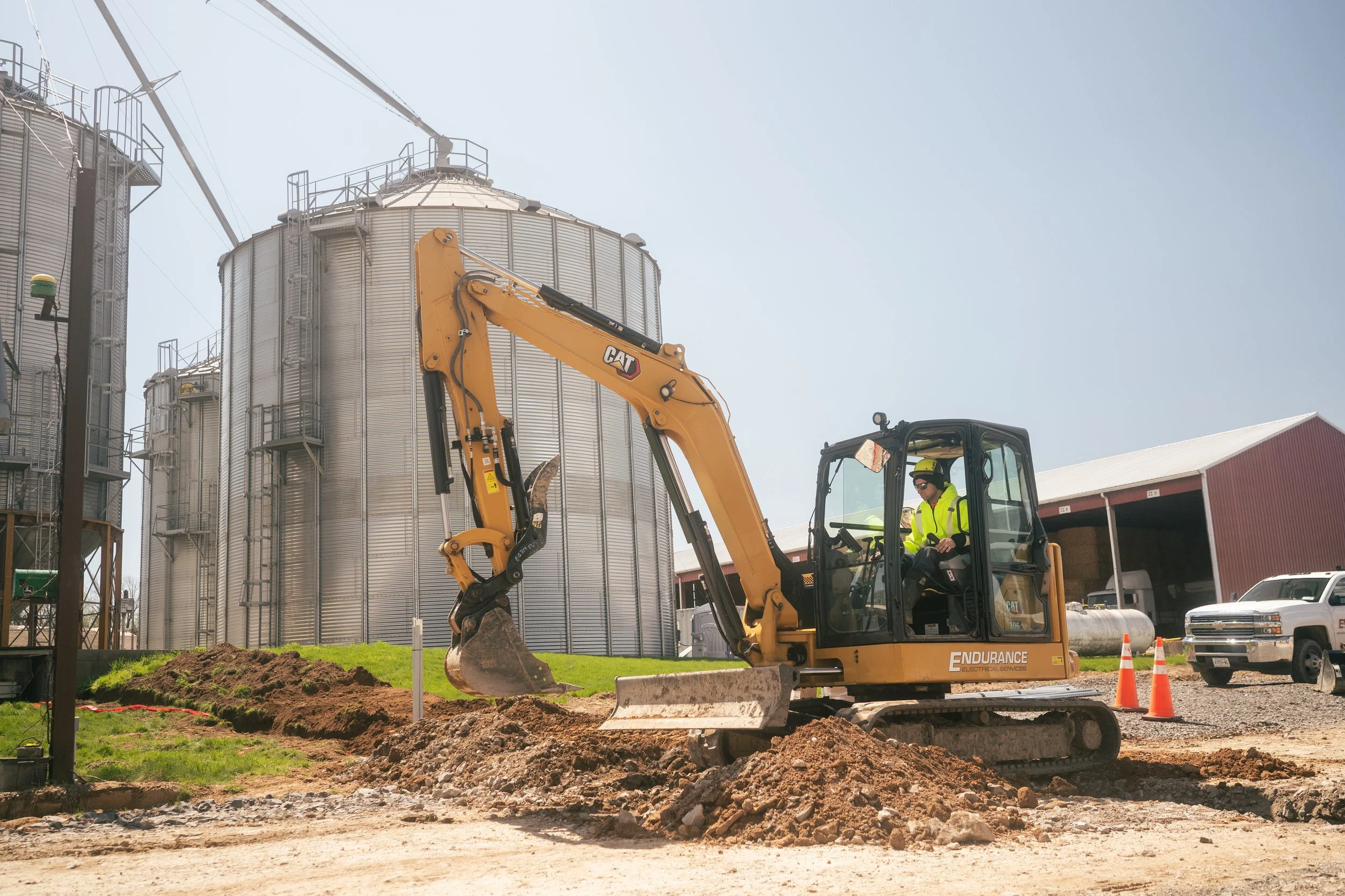 CAT 306 excavator digging a trench at Will-O-Crest Farms to bury conduit