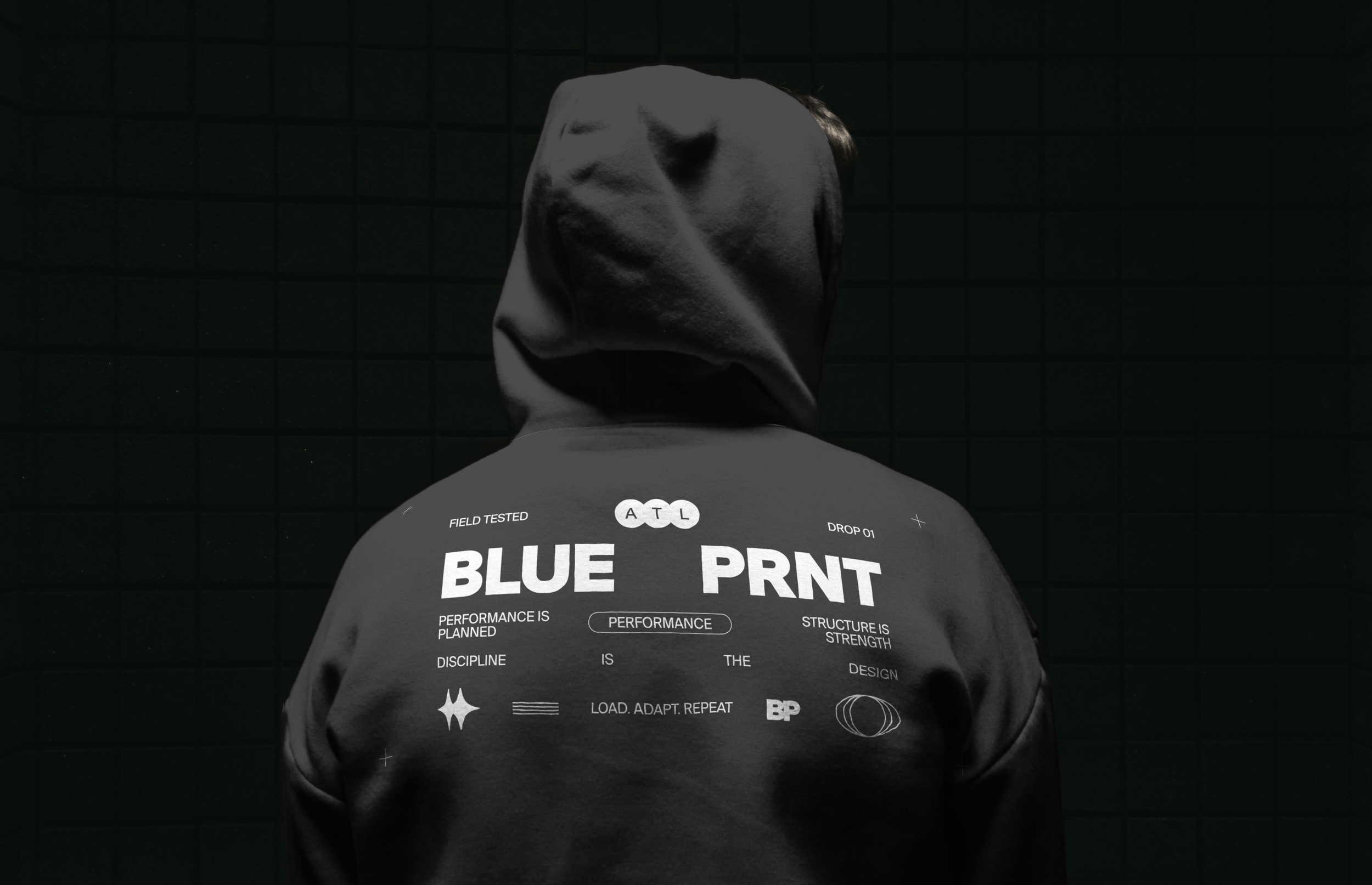 man wearing a hoodie. fitness logo on back with inspirational messaging