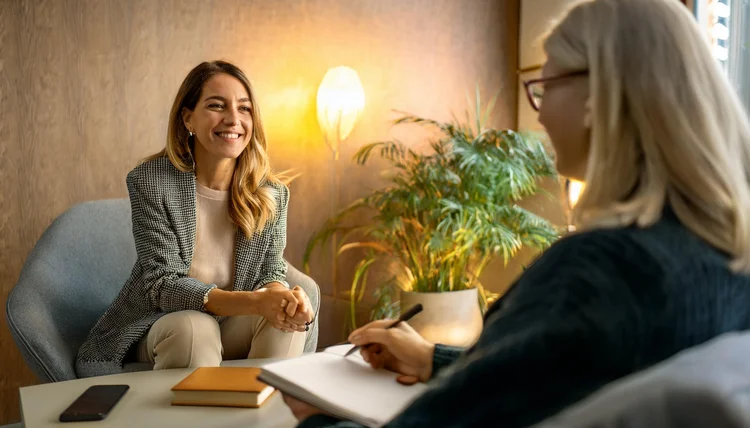 A client and counsellor smiling in a counselling session