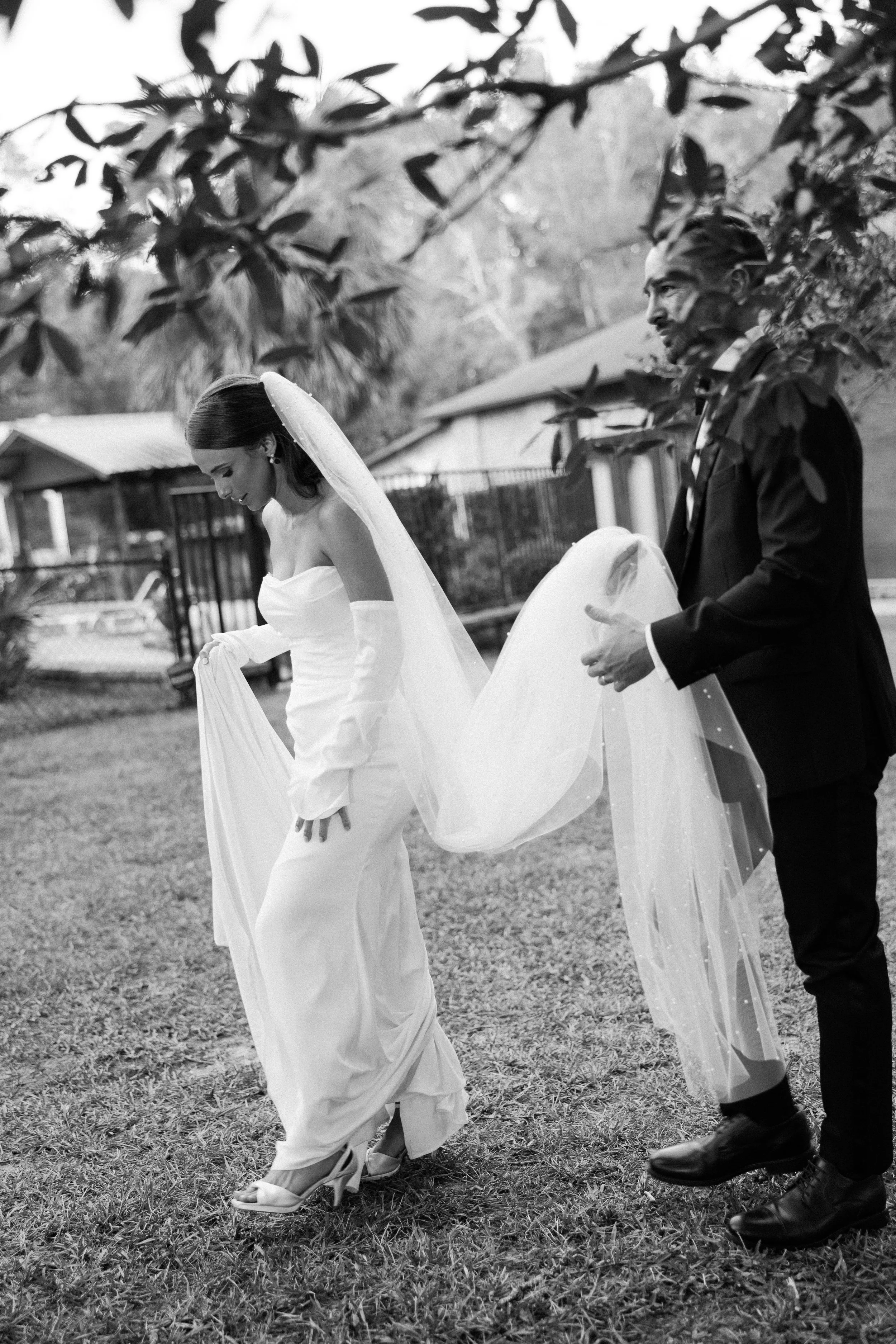 groom carrying brides train rosemary beach 30a wedding