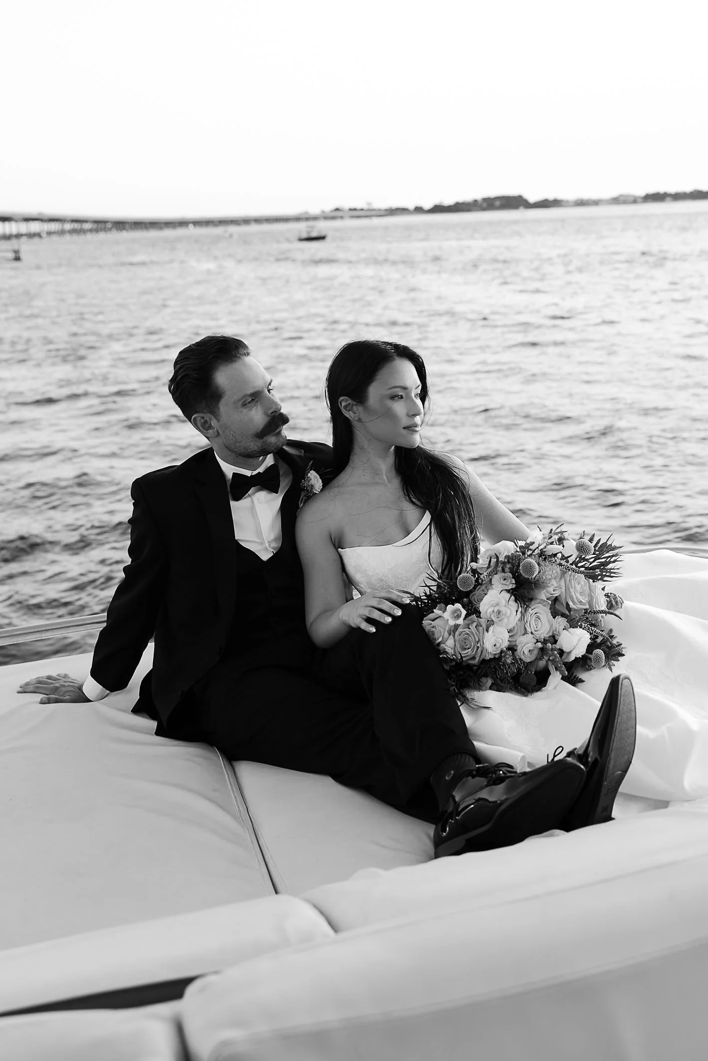 couple sitting on a yacht watching the sunset the Alice Destin wedding