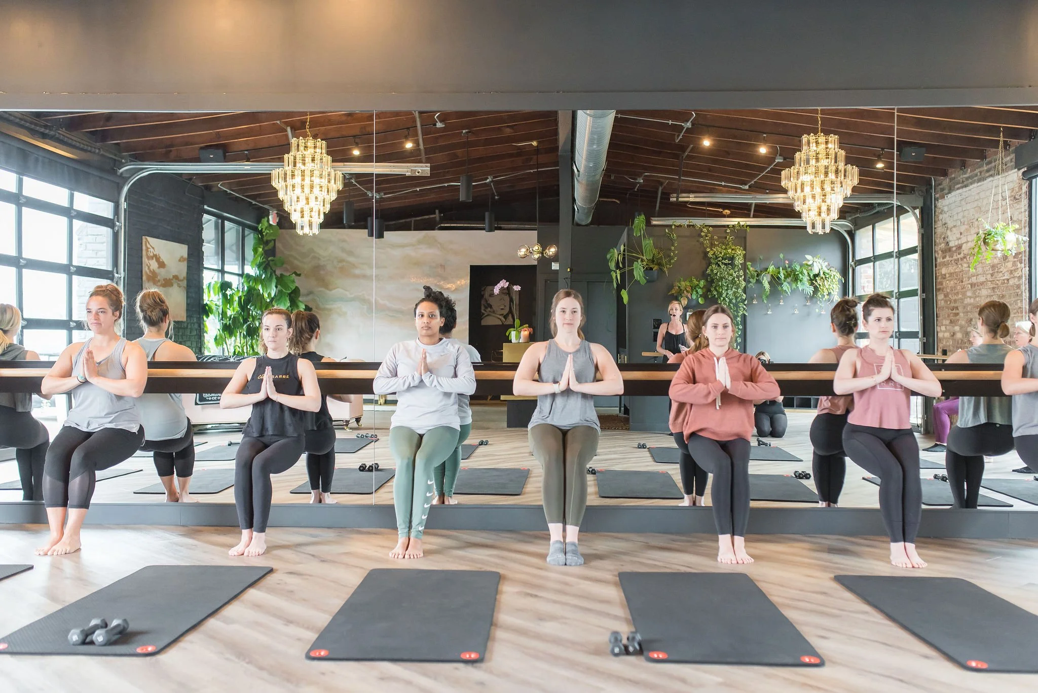 women in the City Barre studio working in a chair position