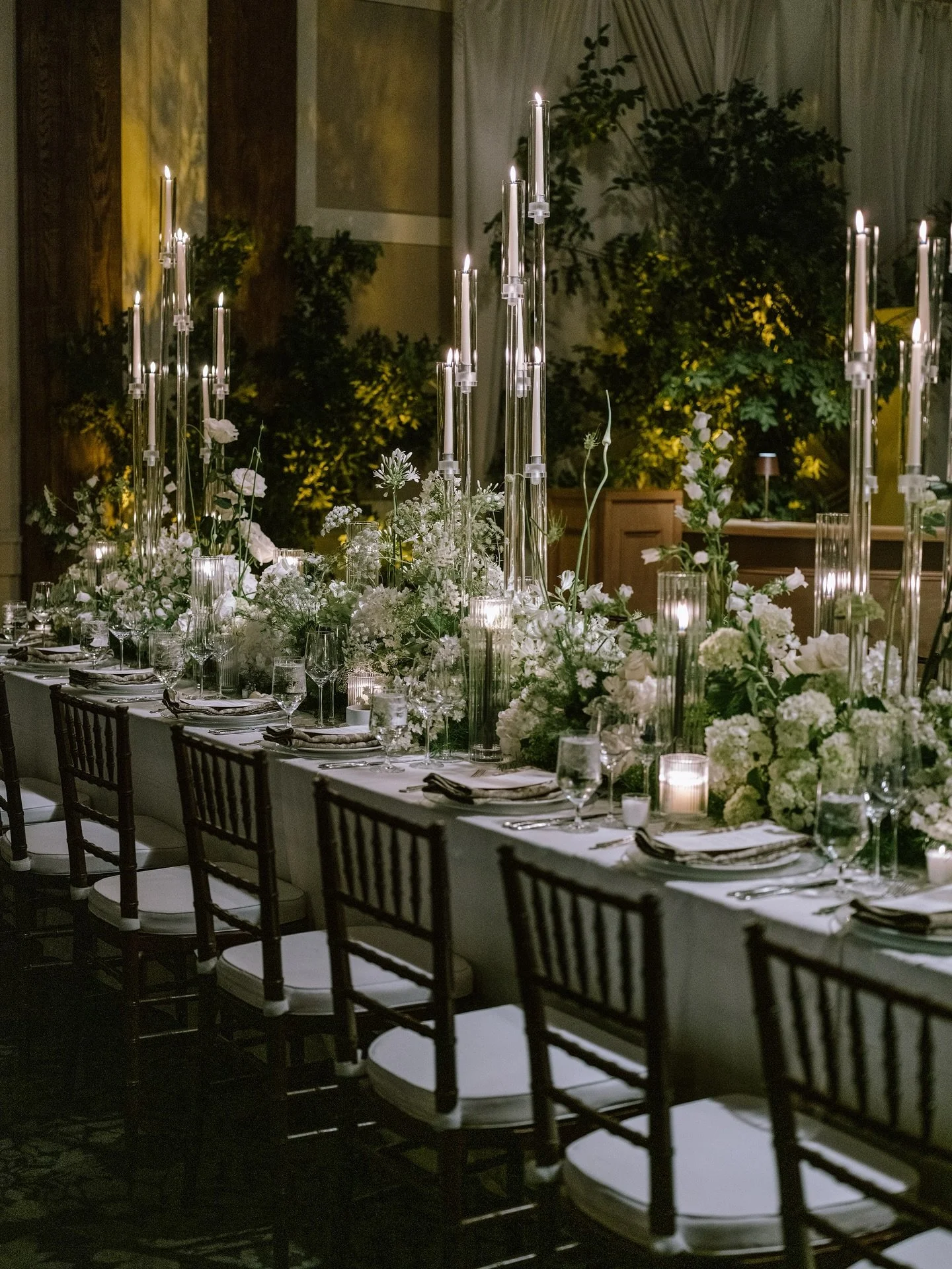 When elegance meets edge, magic happens. This moody ballroom was transformed into a deep, dreamy garden dripping in emerald tones, candlelit shadows, and rich textures. Satin draping, layered florals, and sultry lighting set the stage for a night whe