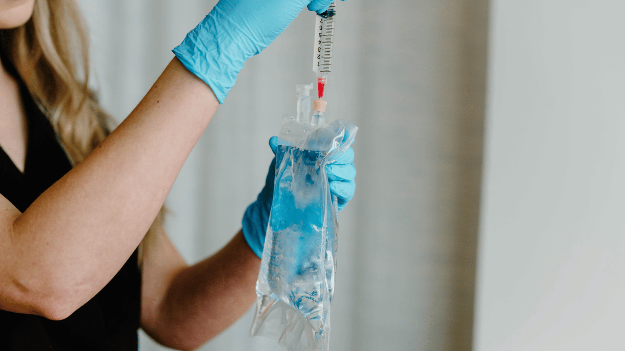 woman injecting an IV bag
