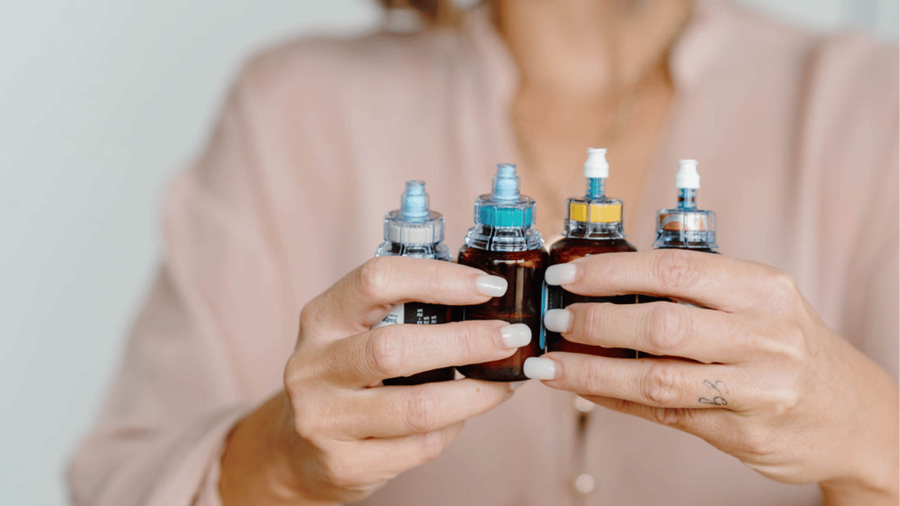 hands holding four ampoules